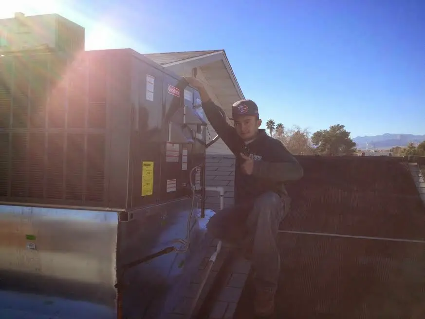 HVAC technician performing Boiler Repair on a rooftop unit in Linganore